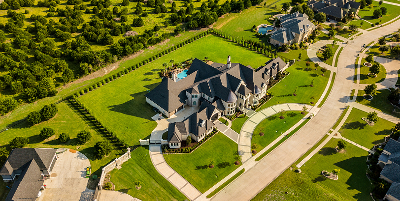 A birds-eye view of a beautiful estate surrounded by fields and forests